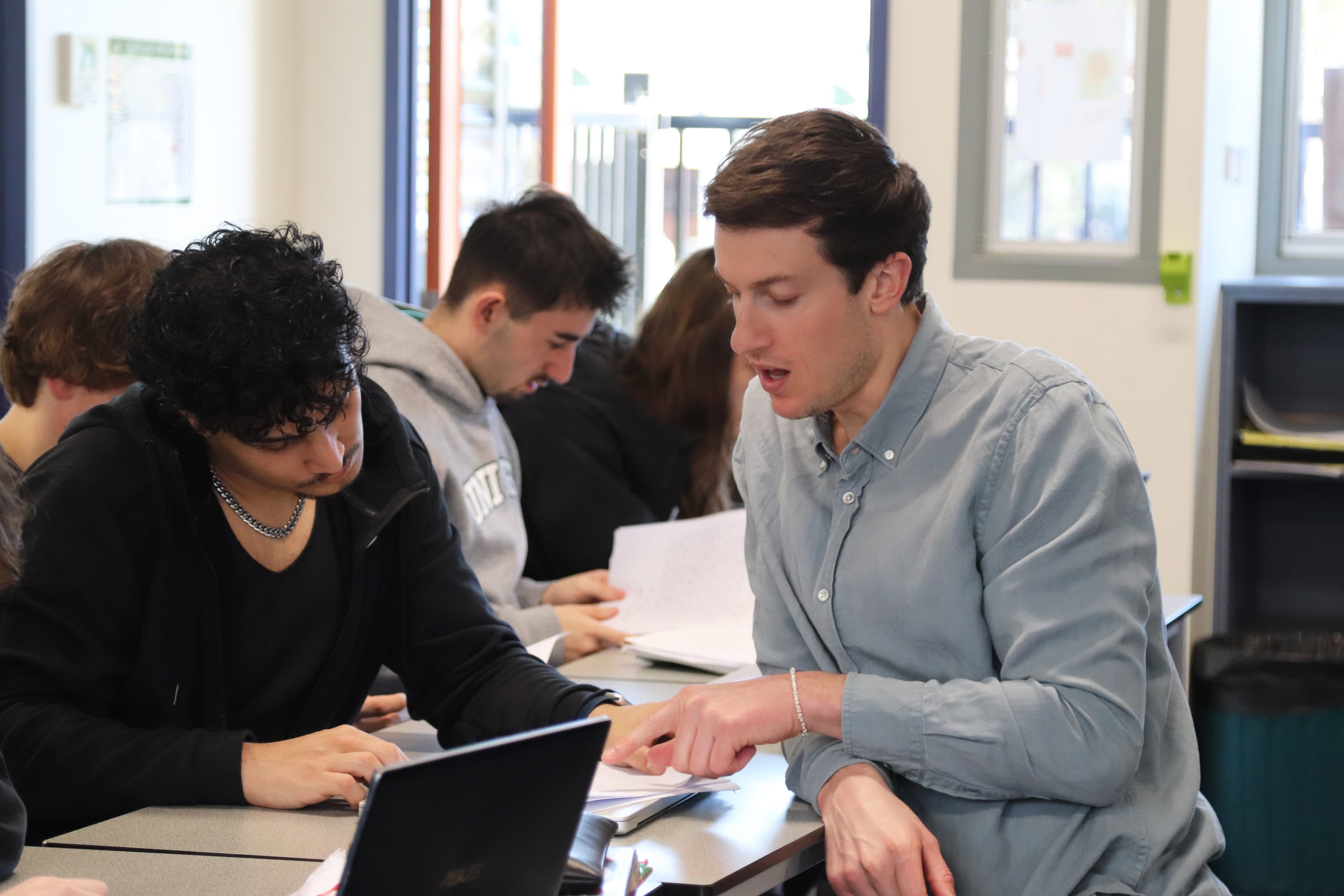 Chris working one-on-one with a student